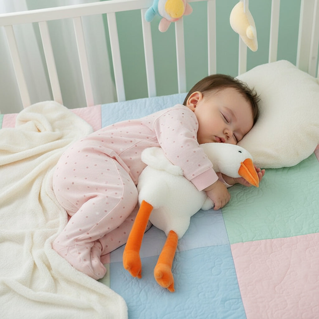 Plush toy goose with an orange beak and feet on a white surface.